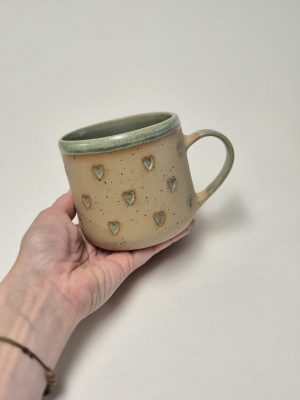 Ceramic mug with green hearts